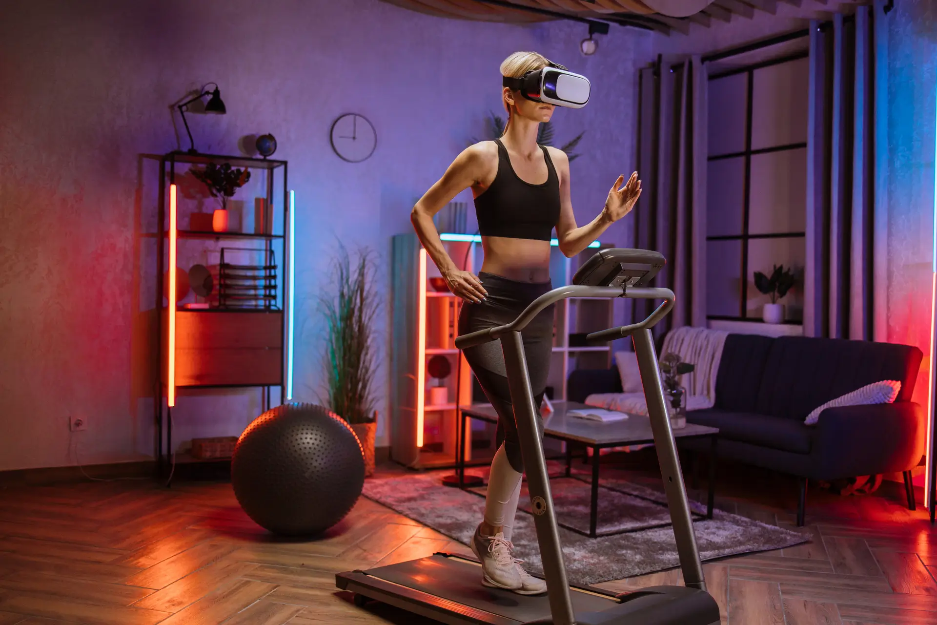 Woman using VR headset while walking on treadmill showcasing Can Virtual Reality Make Physical Therapy Fun? Here's What You Need to Know