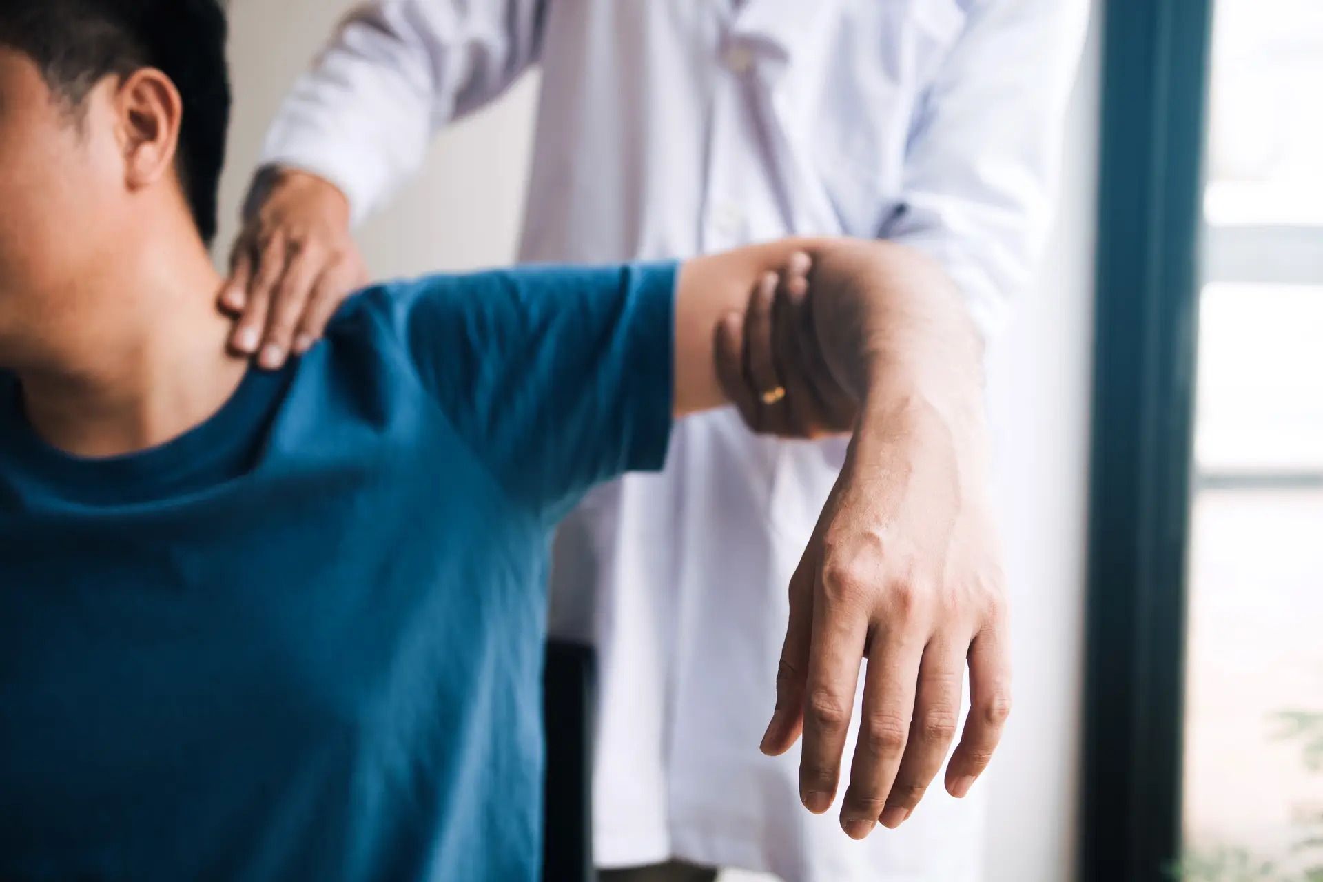 Therapist assisting patient with shoulder movement demonstrating Simple Physio Exercises for Rotator Cuff Pain Relief