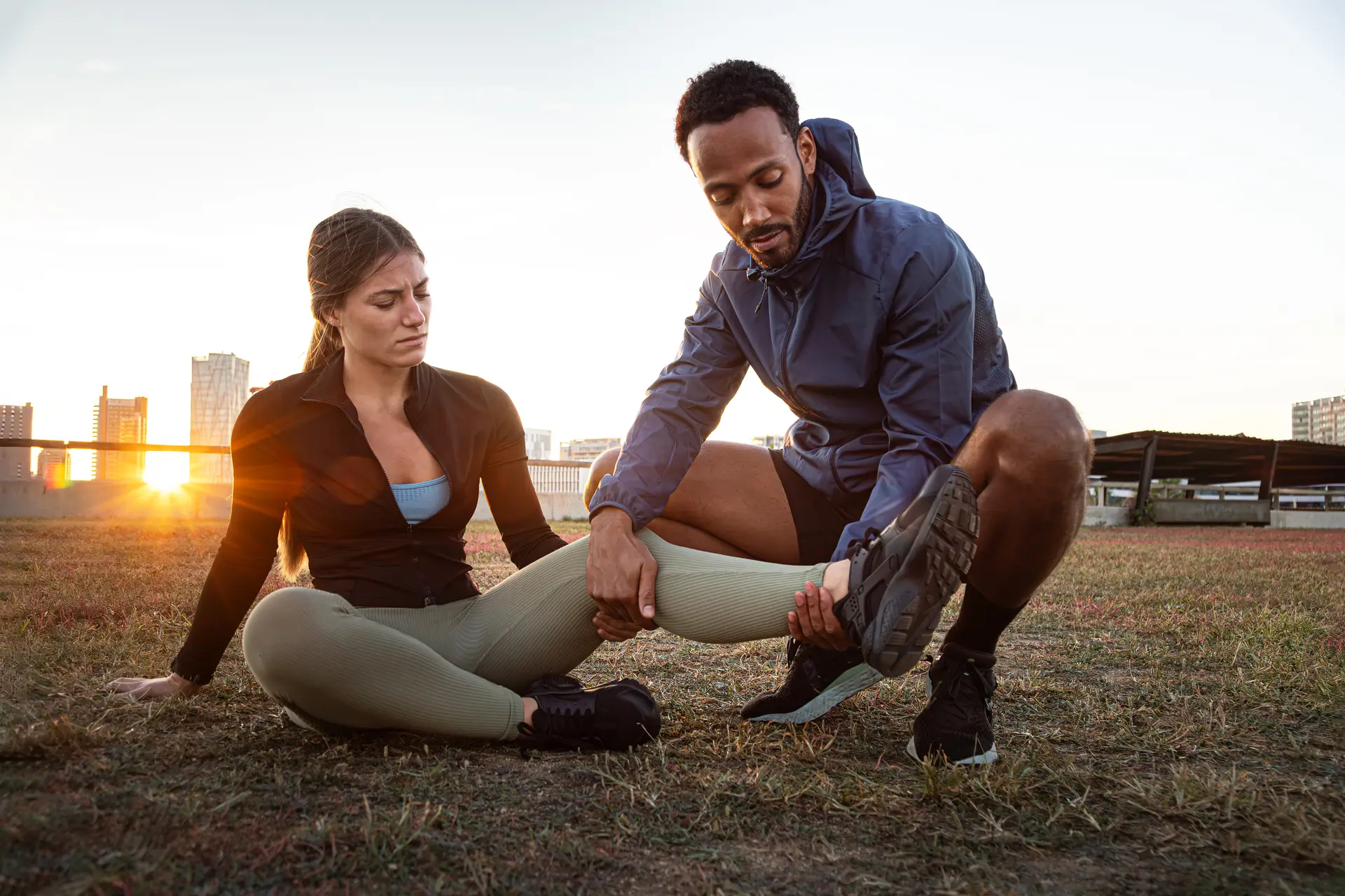 A professional therapist examining a patient's leg to identify symptoms of a hamstring strain during a physiotherapy Edmonton session at In Step Physical Therapy.