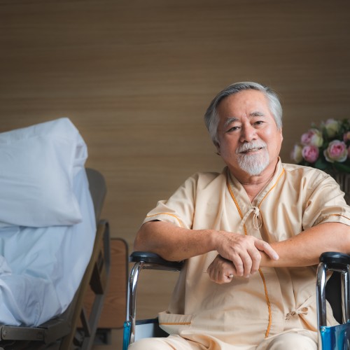 An Elderly Male Patient Resting In A Clinical Bed, Illustrating Post-Surgical Recovery And Inpatient Care During Physiotherapy Edmonton At In Step Physical Therapy. An Elderly Male Patient Resting In A Clinical Bed, Illustrating Post-Surgical Recovery And Inpatient Care During Physiotherapy Edmonton At In Step Physical Therapy.