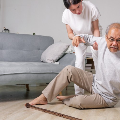 An Elderly Man Receiving Assistance After A Slip And Fall Accident, Highlighting The Importance Of Fall Prevention And Recovery During Physiotherapy Edmonton At In Step Physical Therapy. An Elderly Man Receiving Assistance After A Slip And Fall Accident, Highlighting The Importance Of Fall Prevention And Recovery During Physiotherapy Edmonton At In Step Physical Therapy.