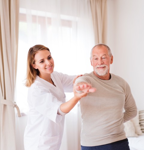 A Professional Healthcare Visitor Consulting With A Senior Man During A Home Visit, Discussing Mobility Goals As Part Of Physiotherapy Edmonton At In Step Physical Therapy.