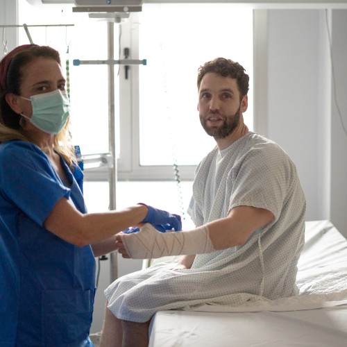 A Healthcare Professional Applying A Compression Bandage To A Patient&Amp;Apos;S Arm In A Clinical Setting During A Physiotherapy Edmonton Session At In Step Physical Therapy. A Healthcare Professional Applying A Compression Bandage To A Patient&Amp;Apos;S Arm In A Clinical Setting During A Physiotherapy Edmonton Session At In Step Physical Therapy.