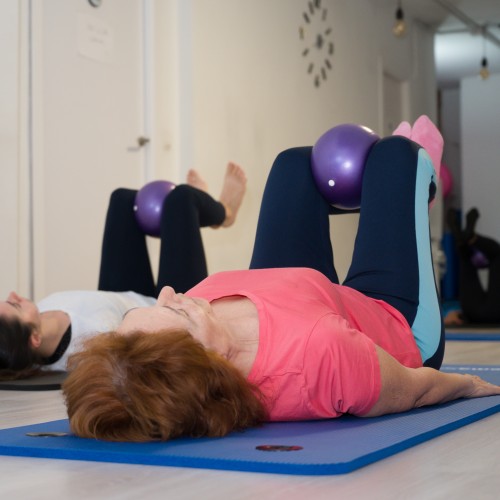 A Woman Practicing A Yoga Pose On A Mat, Demonstrating Flexibility And Core Strength During A Physiotherapy Edmonton Wellness Session At In Step Physical Therapy.